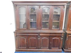 A double fronted mahogany bookcase with bevelled g