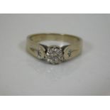 A ladies 18ct gold ring set with three small diamon