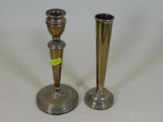 A silver candlestick, fault to base twinned with s