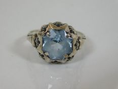 A vintage silver ring set with blue stone