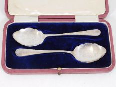 A cased pair of silver spoons