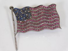A silver USA flag set with diamonds, rubies & sapp