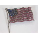 A silver USA flag set with diamonds, rubies & sapp