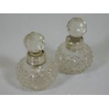 A pair of silver collared scent bottles