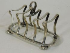 A silver toast rack of waisted design