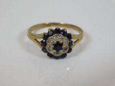 A yellow metal ring set with sapphires & diamonds