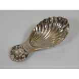 A silver caddy spoon of shell form