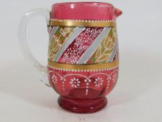 A Victorian cranberry jug with applied decor