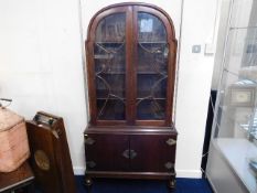 A mahogany art deco bookcase with cupboard under