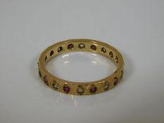 A yellow metal ring set with diamond & ruby
