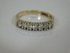 A 9ct gold ring set with seven small diamonds