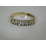 A 9ct gold ring set with seven small diamonds