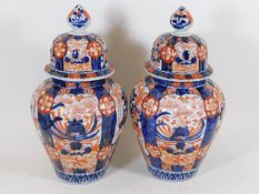 A pair of Japanese lidded imari vases