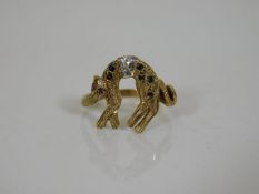 A yellow metal ring depicting a cat set with diamo