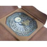 A leather bound miniature sundial timepiece