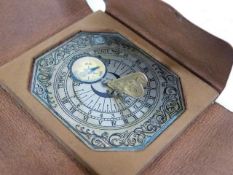 A leather bound miniature sundial timepiece