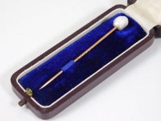 A Victorian gold tie pin set with pearl