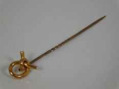 An antique tie pin with 15ct gold knot