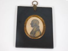 A 19thC. framed silhouette with indistinct inscrip