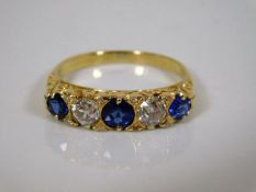 An 18ct gold five stone ring with diamond & sapphi