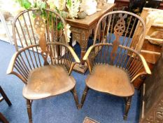 A pair of antique elm seated Windsor chairs