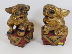 Two 19thC. Chinese carved foo dog figures with gil