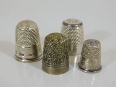 Four silver & white metal thimbles