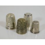 Four silver & white metal thimbles