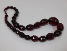 A set of antique red amber faceted beads