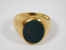 An 18ct gold heavy gauge gents cygnet ring set wit