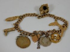 A gold bracelet set with gold & silver charms