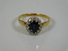An 18ct gold ring set with sapphire & diamond