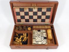 A 19thC. games travel box featuring draughts, ches