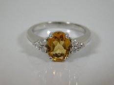 A white metal ring set with citrine & diamonds