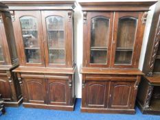 A pair of matching mahogany bookcases with bevelle