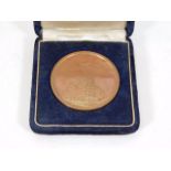 A bronze commemorative coin with case