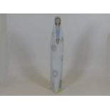 A tall Lladro nun figure praying