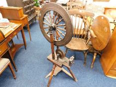 An 18thC. spinning wheel with elm pedal