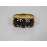 A 9ct gold ring set with garnets