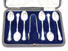 A cased set of silver spoons with tongs