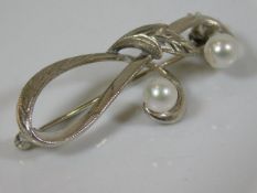 A white metal & pearl brooch