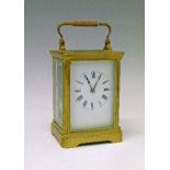 Early 20th Century French brass cased carriage clock, the white enamel dial with Roman numerals