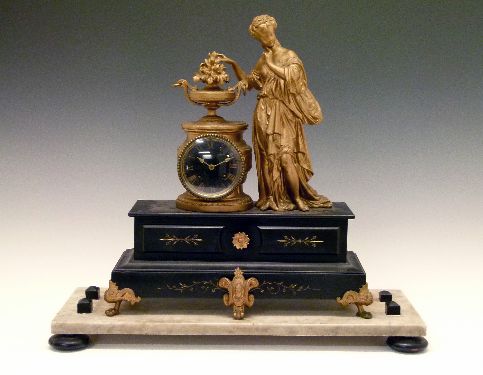 Late 19th Century French black slate and gilded spelter figural cased mantel clock surmounted with a