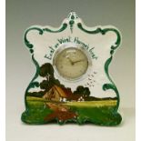 Pottery cased mantel clock having painted decoration depicting a cottage in a landscape and