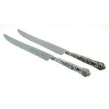 Two Elizabeth II silver handled knives, each having a serrated blade, Sheffield 1977 Condition: