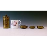 Three vintage brass pocket watch protection cases, a 19th Century English porcelain mug with painted