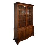 Reproduction mahogany bookcase fitted three adjustable shelves enclosed by a pair of glazed doors,