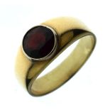 Yellow metal dress ring set circular garnet in a rubover setting, size S Condition: