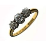 Graduated three stone diamond ring, the shank stamped '18ct and Pt.', size N Condition: