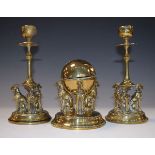 Pair of early 20th Century brass desk candlesticks, each having figural decoration depicting three